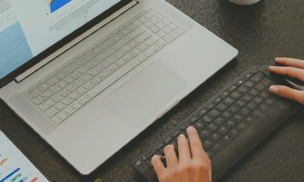 A person using a laptop to analyze data from Google Analytics 4, with a focus on understanding user behavior and optimizing website performance.